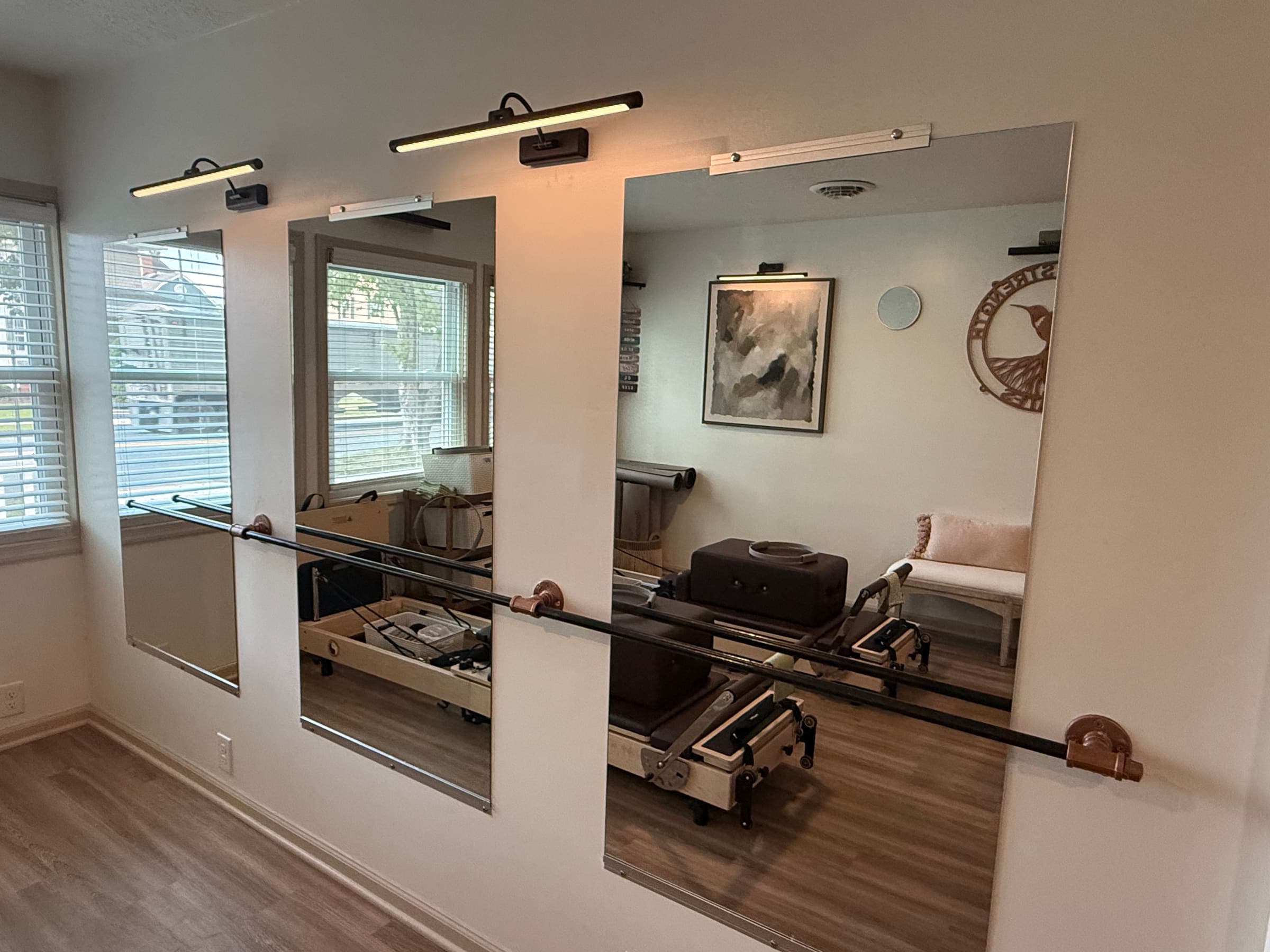 Mirrored wall and ballet barre in the Rooted in Strength Pilates studio in Seaford, DE